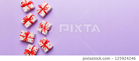Valentine day composition: red gift box with bow and heart. Christmas present. View from above. Space for text. Holday greeting card Valentine day composition: red gift box with bow and heart. Christmas present. View from above. Space for text. Holday greeting card 125924246