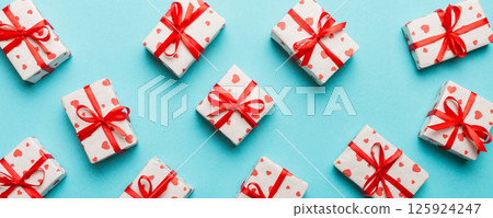 Valentine day composition Background: red gift box with bow and heart. Christmas present. View from above. Holday greeting card Valentine day composition Background: red gift box with bow and heart. Christmas present. View from above. Holday greeting card 125924247