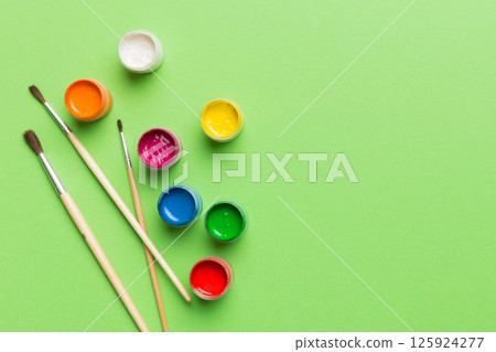 art palette with paint and brushes, close up. Top view with empty space. workplace for creativity. home teaching concept drawing art palette with paint and brushes, close up. Top view with empty space. workplace for creativity. home teaching concept drawing 125924277