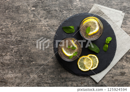 Healthy breakfast or morning with chia seeds lemon and mint on table background, vegetarian food, diet and health concept. Chia pudding with lemon and mint 125924594