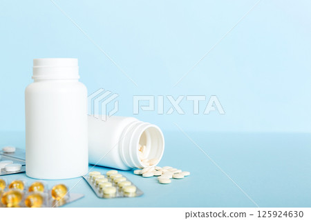 Medicine for treatment HIV infection. Pills and capsules and battle on the table. Different colorful tablets at colored background with copy space 125924630
