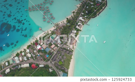 Capturing aerial beauty of Bora Bora from above, turquoise lagoon, overwater bungalows, houses and beach coastline hotels, vibrant coral reef, tropical paradise. Wild travel destination, remote nature 125924733
