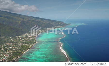 Aerial drone captures the stunning coastline of Tahiti island, showcasing the vibrant turquoise coral reef, lush green mountains, cityscape village and the vast expanse of the pacific ocean Aerial drone captures the stunning coastline of Tahiti island, showcasing the vibrant turquoise coral reef, lush green mountains, cityscape village and the vast expanse of the pacific ocean 125924864