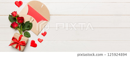 Valentine day composition with envelope, rose flower and red heart on table. Top view, flat lay, copy space Holiday concept 125924894