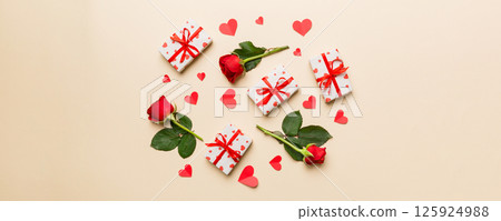 Kraft Gift box with beautiful red ribbon and rose, concept of Valentine day, anniversary, mother day and birthday greeting, copy space, top view Kraft Gift box with beautiful red ribbon and rose, concept of Valentine day, anniversary, mother day and birthday greeting, copy space, top view 125924988