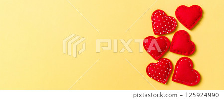 Composition of textile red hearts on colorful background with empty space for your design. Top view of St. Valentine's day concept Composition of textile red hearts on colorful background with empty space for your design. Top view of St. Valentine's day concept 125924990