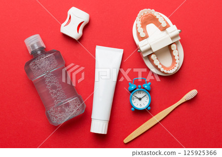 Mouthwash and other oral hygiene products on colored table top view with copy space. Flat lay. Dental hygiene. Oral care kit. Dentist concept 125925366
