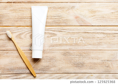 toothpaste and toothbrush top view with copy space on colored background. Flat lay. Dental hygiene. Oral care products on light background. Body care concept toothpaste and toothbrush top view with copy space on colored background. Flat lay. Dental hygiene. Oral care products on light background. Body care concept 125925368