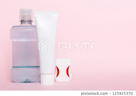 Mouthwash and other oral hygiene products on colored table top view with copy space. Flat lay. Dental hygiene. Oral care products and space for text on light background. concept 125925370