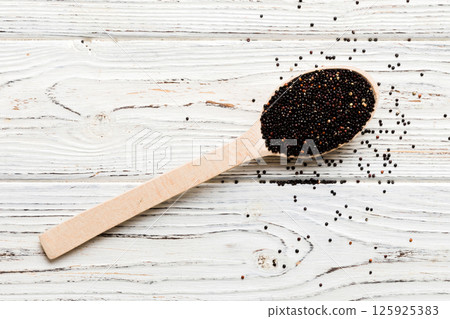 quinoa seeds in spoon on colored background. Healthy kinwa in small spoon. Healthy superfood quinoa seeds in spoon on colored background. Healthy kinwa in small spoon. Healthy superfood 125925383