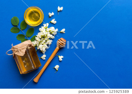 honey jar with acacia flowers and leaves. fresh honey top view flat lay 125925389