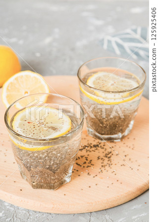 Healthy breakfast or morning with chia seeds and lemon on table background, vegetarian food, diet and health concept. Chia pudding with lemon Healthy breakfast or morning with chia seeds and lemon on table background, vegetarian food, diet and health concept. Chia pudding with lemon 125925406