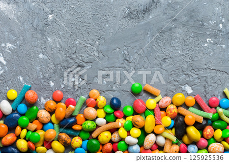 Mixed collection of colorful candy, on colored background. Flat lay, top view. frame of colorful chocolate coated candy Mixed collection of colorful candy, on colored background. Flat lay, top view. frame of colorful chocolate coated candy 125925536