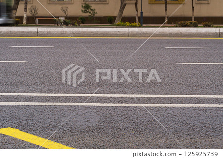 An empty multi-lane city highway, a road without cars. A symbol of the morning, afternoon lull on a weekend before start of the transport collapse. Problem with regulation of car traffic in cities An empty multi-lane city highway, a road without cars. A symbol of the morning, afternoon lull on a weekend before start of the transport collapse. Problem with regulation of car traffic in cities 125925739