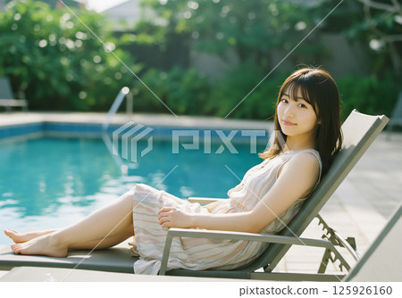 Young woman relaxing by the pool 125926160