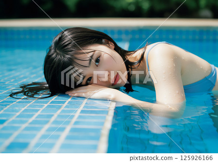 Young woman relaxing by the pool 125926166