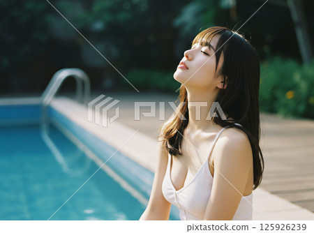 Young woman relaxing by the pool 125926239