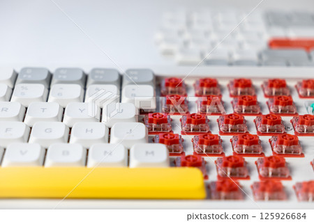 Close-up detail of red mechanical keyboard switches and customizable keycap arrangement Close-up detail of red mechanical keyboard switches and customizable keycap arrangement 125926684
