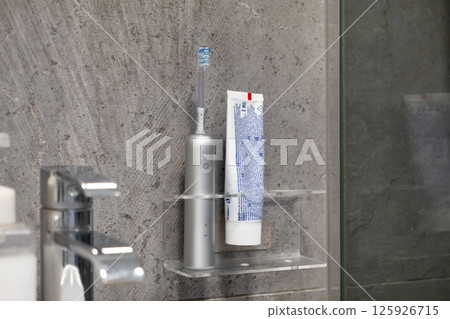 Modern electric toothbrush toothpaste symbolize daily oral hygiene routine bathroom Modern electric toothbrush toothpaste symbolize daily oral hygiene routine bathroom 125926715