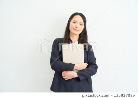 A woman with long hair wearing a jacket A woman with long hair wearing a jacket 125927089