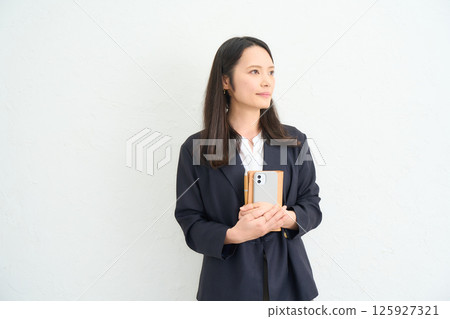 A woman with long hair wearing a jacket 125927321