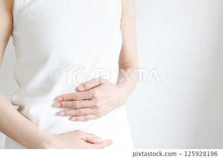 A woman suppressing her stomach A woman suppressing her stomach 125928196