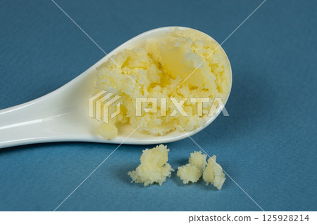 Natural Indian Traditional Ghee Butter Clarified Butter In Spoon Close-Up Natural Indian Traditional Ghee Butter Clarified Butter In Spoon Close-Up 125928214
