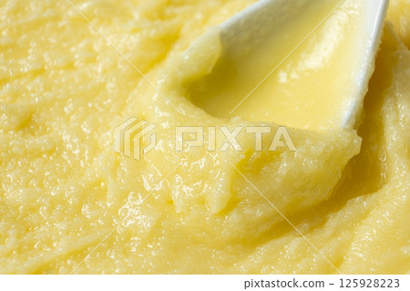 Natural Indian Traditional Ghee Butter Clarified Butter In Spoon Close-Up Natural Indian Traditional Ghee Butter Clarified Butter In Spoon Close-Up 125928223