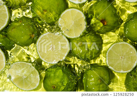 Fresh Lime Halves Floating in Water Top View 125928250