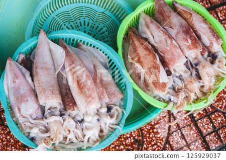 catch of squid. Chilled fresh squid at seafood street market in Asia 125929037