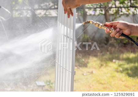 air conditioning filter cleaning with water spray air conditioning filter cleaning with water spray 125929091