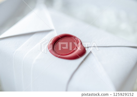 Wax seal stamp on white paper wrap packaging parcel box 125929152