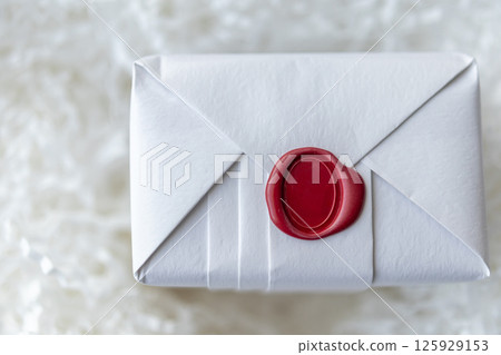 Wax seal stamp on white paper wrap packaging parcel box 125929153