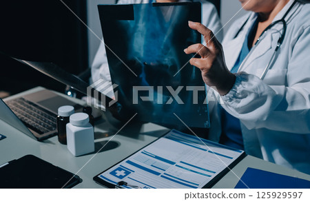 Male and female doctors are having a meeting in a hospital room. Male and female doctors are having a meeting in a hospital room. 125929597