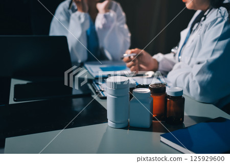 Male and female doctors are having a meeting in a hospital room. Male and female doctors are having a meeting in a hospital room. 125929600