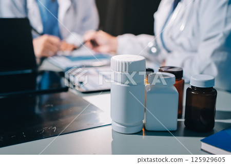Male and female doctors are having a meeting in a hospital room. 125929605