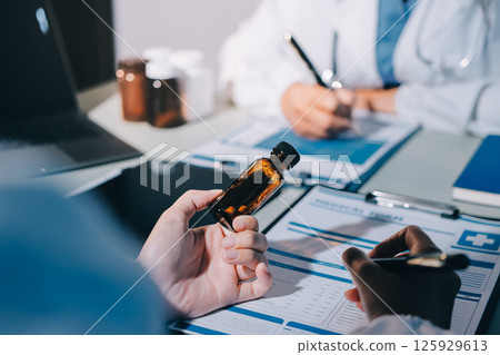 Male and female doctors are having a meeting in a hospital room. 125929613