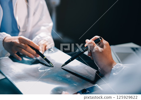 Male and female doctors are having a meeting in a hospital room. 125929622