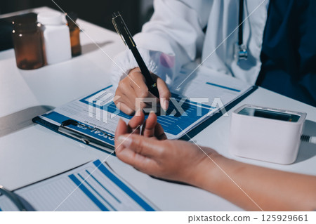 Nurse measuring blood pressure of elderly woman at table, closeup. Assisting senior generation Nurse measuring blood pressure of elderly woman at table, closeup. Assisting senior generation 125929661