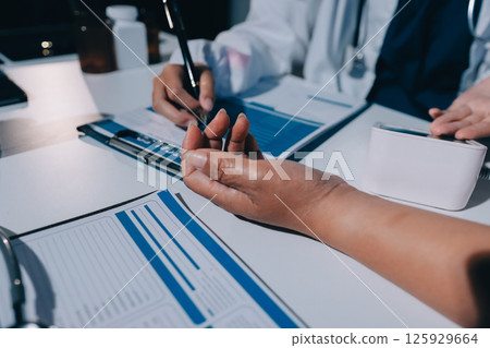 Nurse measuring blood pressure of elderly woman at table, closeup. Assisting senior generation 125929664