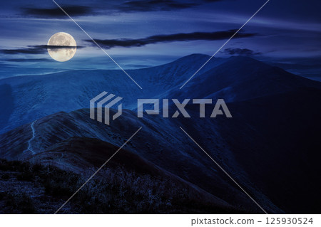 mountain landscape at night. path through hill side to the mountain top. wonderful countryside scenery in full moon light 125930524