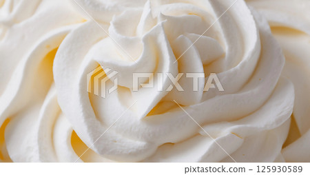 Creamy whipped topping swirls beautifully arranged to enhance desserts and beverages. Close up dessert background. 125930589