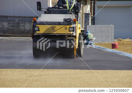 Paving work being done on a walkway in a housing development 125930607