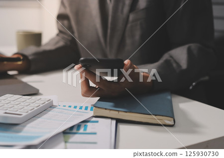 Working from home, Closeup business woman using laptop computer and analyzing financial report. Working from home, Closeup business woman using laptop computer and analyzing financial report. 125930730