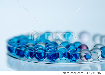 Collagen molecules in Petri dish on blue. Hyaluronic acid skin care, collagen serum drop. Abstract moisturiser collagen peptide serum drop. 125930966