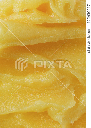 Abstract yellow sugar body exfoliating scrub texture. Melon scrub for body or face pilling. Skin care body moisturizer scrub background. 125930967