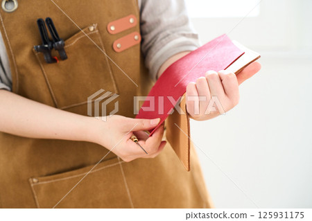 A woman making handmade leather products - Leather craft A woman making handmade leather products - Leather craft 125931175