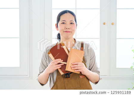A woman making handmade leather products - Leather craft A woman making handmade leather products - Leather craft 125931189