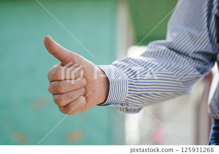 Hands with a finger up. A man's hands. 125931268