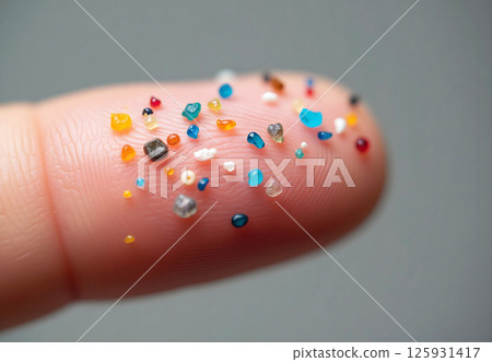 A hand holding a handful of colorful beads A hand holding a handful of colorful beads 125931417